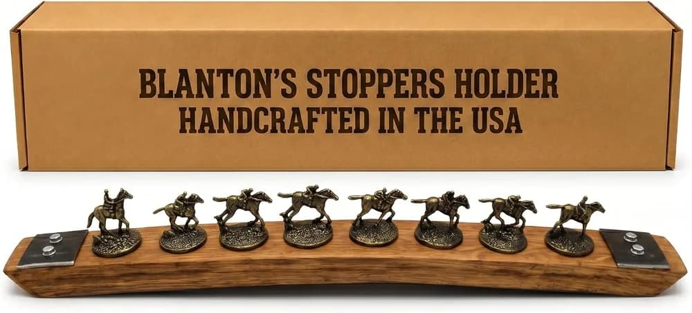 Barrel-Art Blanton's stopper display, an oak barrel stave holding eight brass horse-and-jockey stoppers in a row