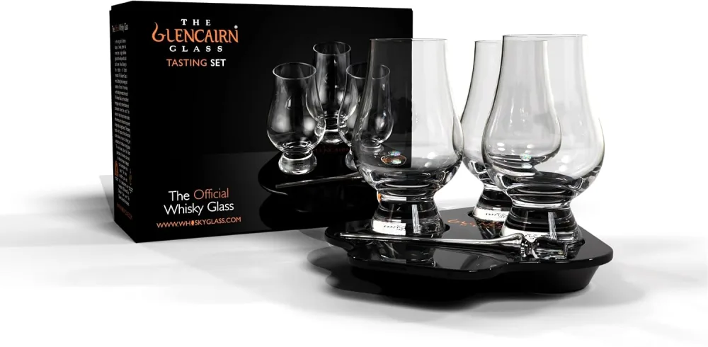 Three Glencairn whisky glasses sitting in a wooden flight tray