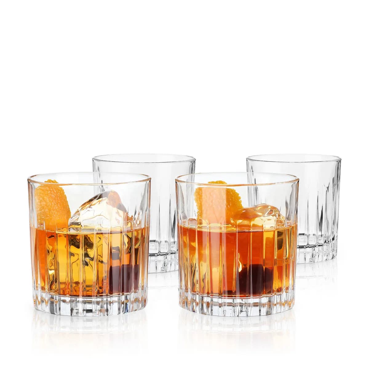 Four Viski Reserve Milo crystal rocks glasses with vertical cuts, holding Old Fashioneds over large ice