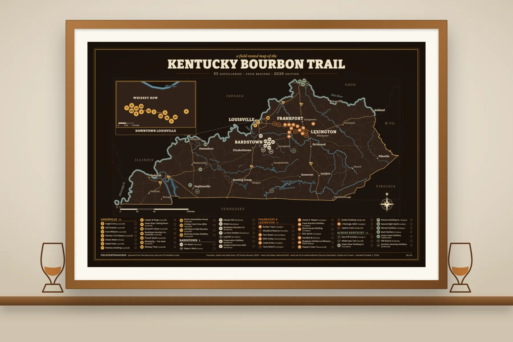 The dark Rickhouse Kentucky Bourbon Trail map framed in oak above a shelf with two tasting glasses